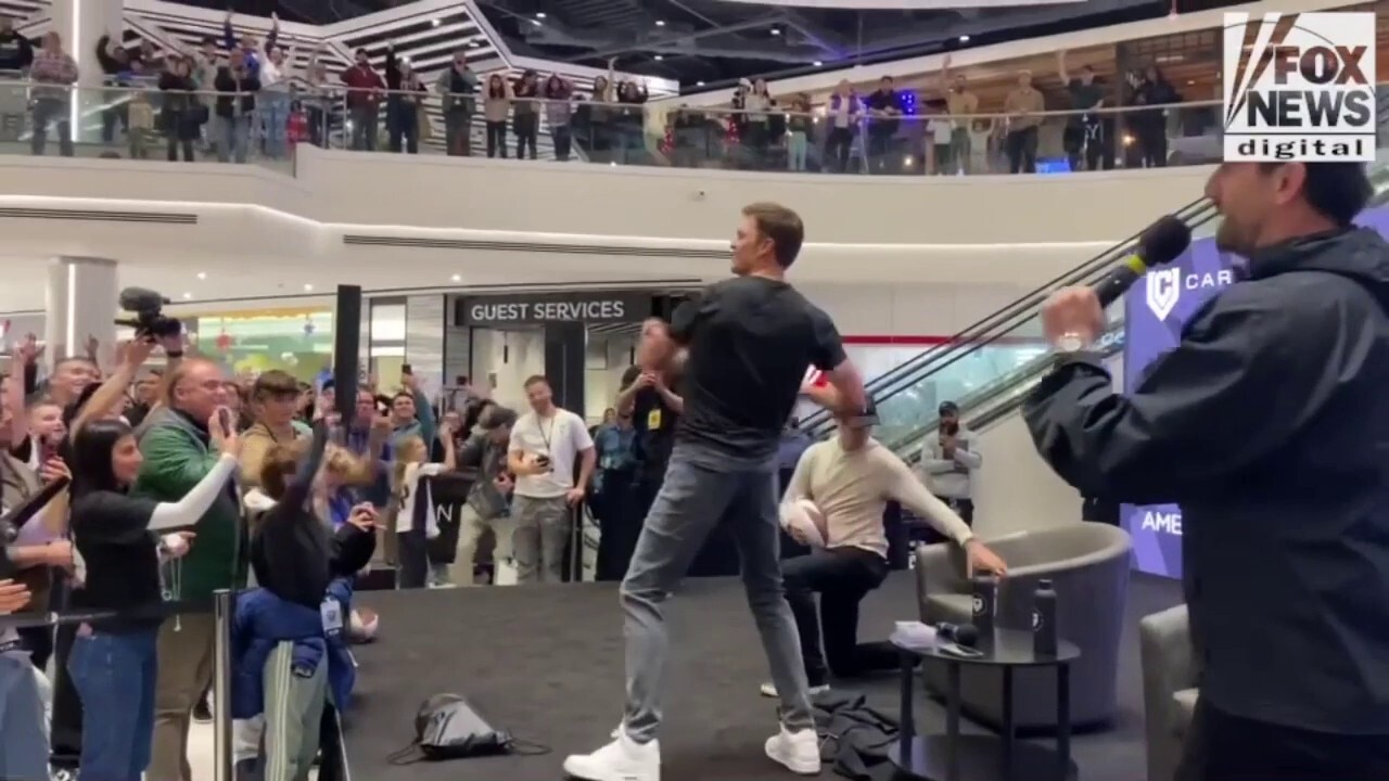 Tom Brady throws footballs as he opens up CardVault in New Jersey