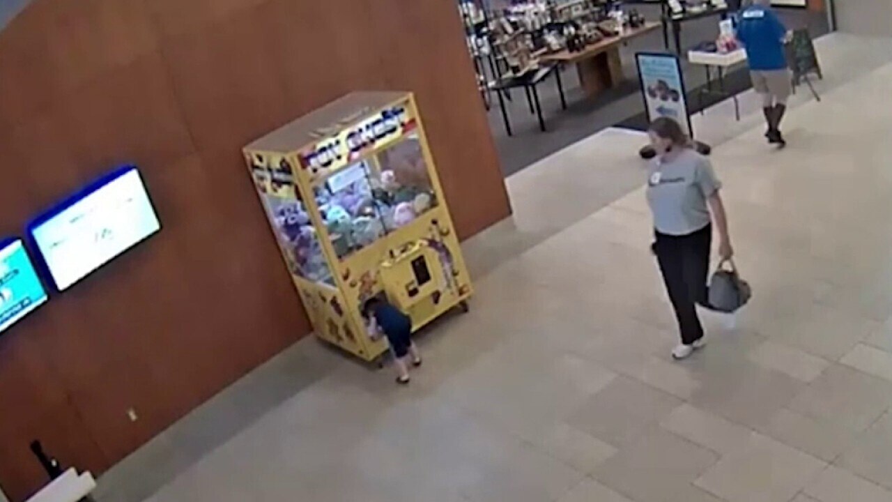 Surveillance video shows boy getting stuck inside claw machine before daring rescue