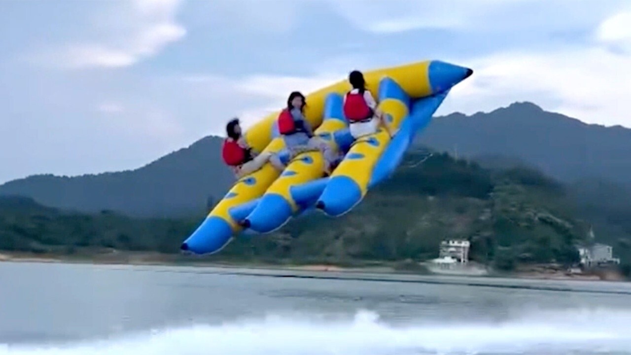 Banana boat goes airborne, sending three riders flying above the water’s surface