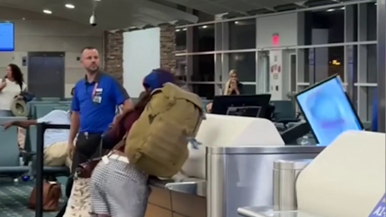 Woman's wild airport tirade caught on camera