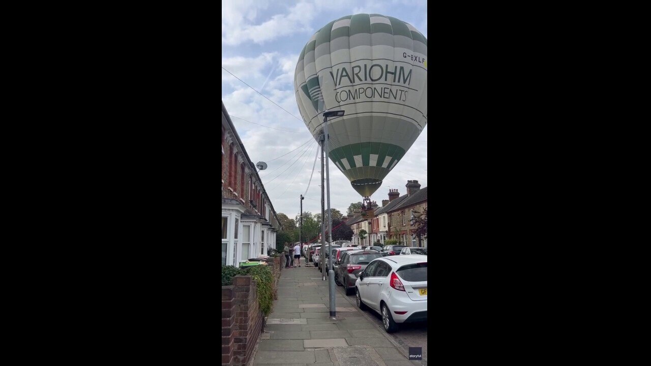 Hot air balloon lands on residential street in dramatic video