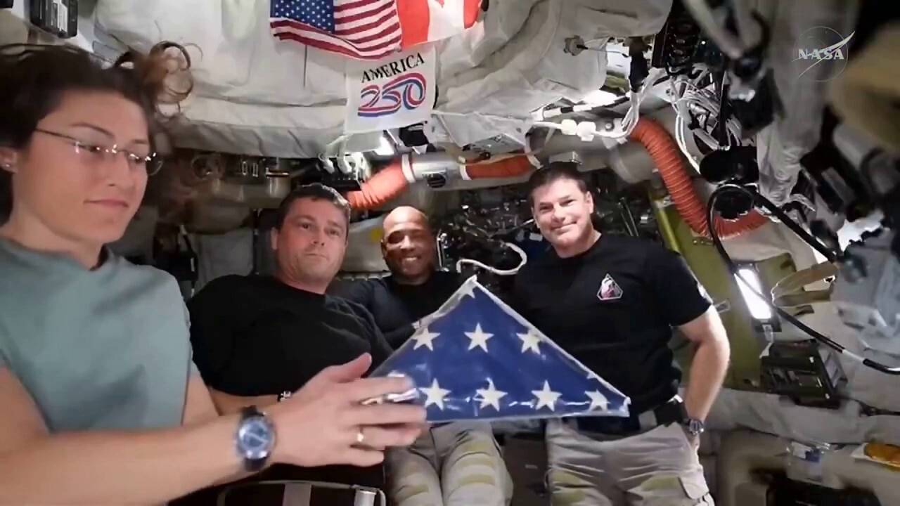 Artemis II astronauts show off Apollo 18 flag from space