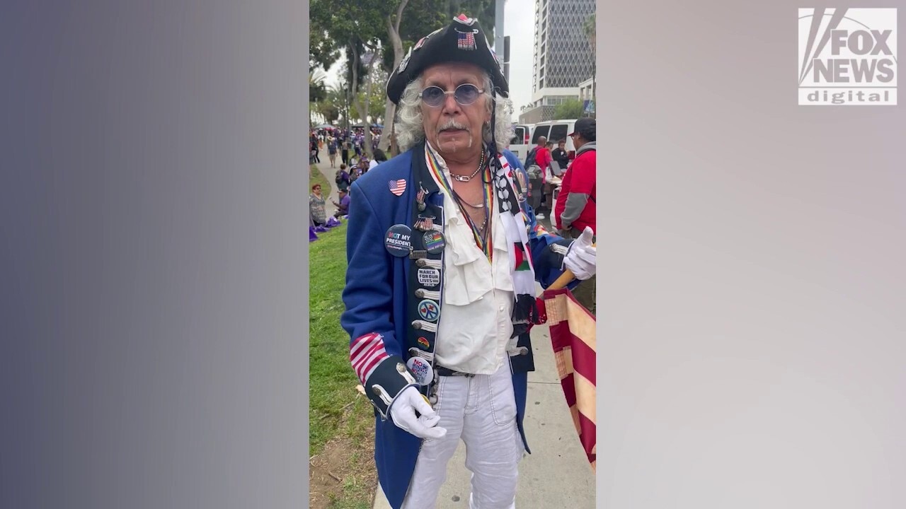 Man in revolutionary costume cites immigration concerns at LA May Day rally