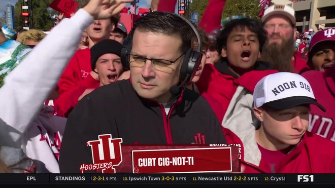 Hoosier the Bison smashes cake on Brutus Buckeye during celebration