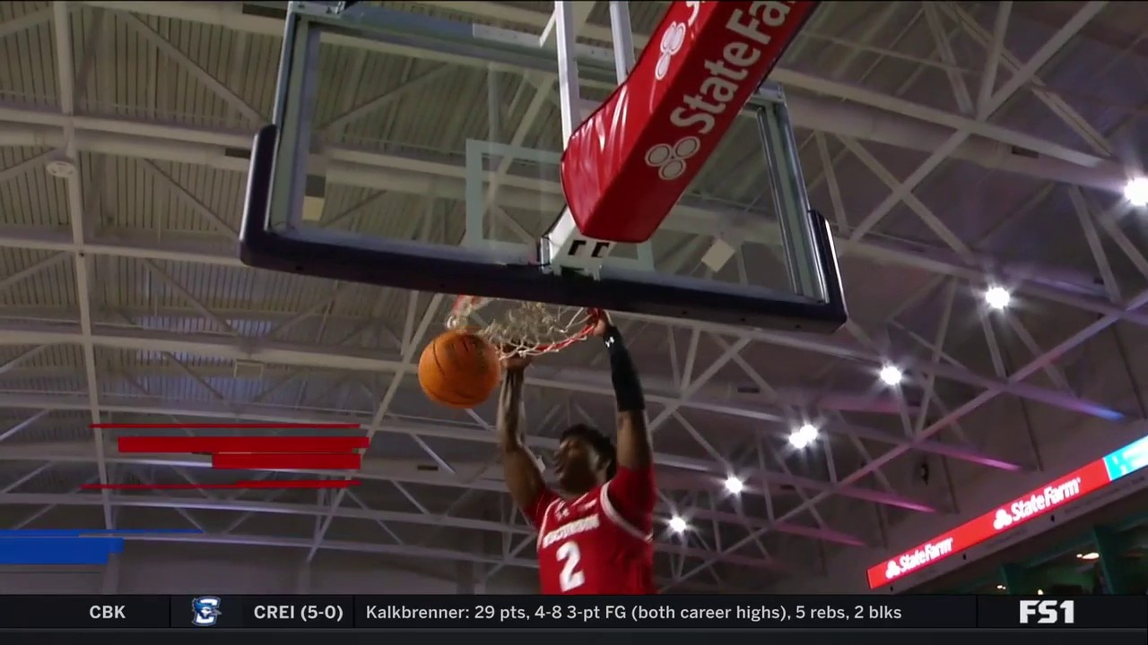 AJ Storr throws down a baseline dunk to help Wisconsin trim SMU's lead