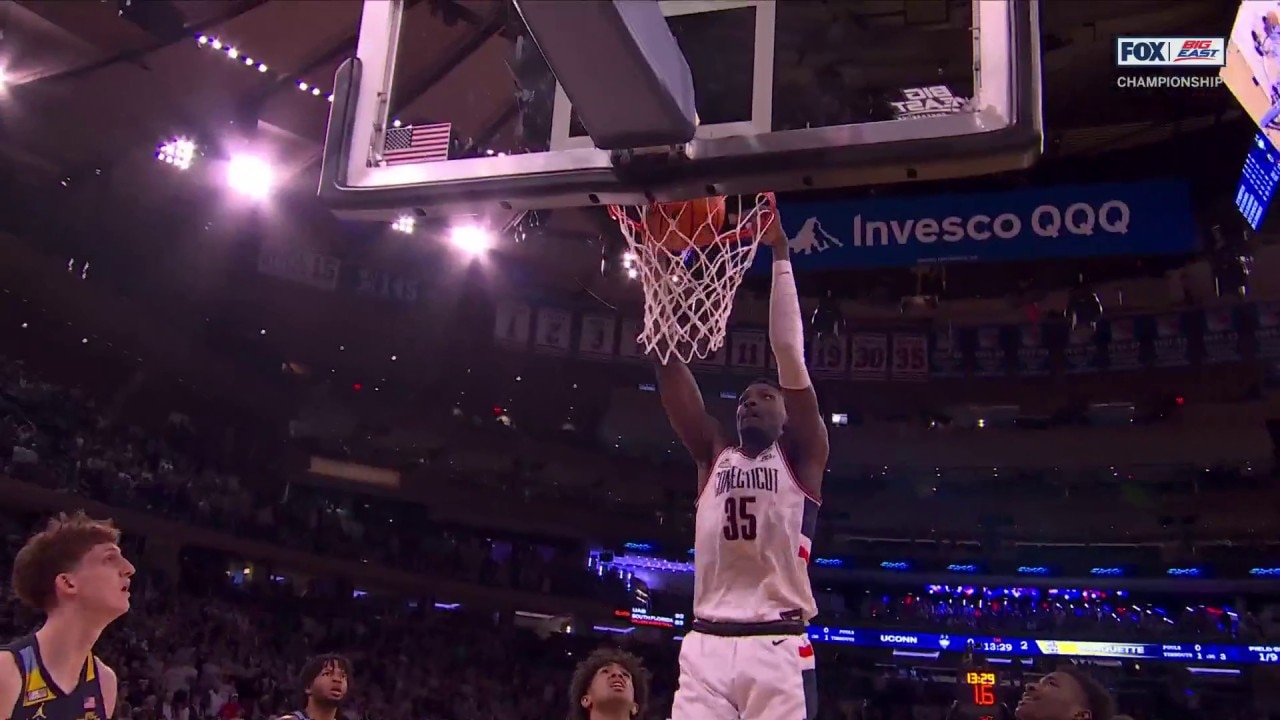 UConn's Tristen Newton finds Samson Johnson inside for the slam against Marquette