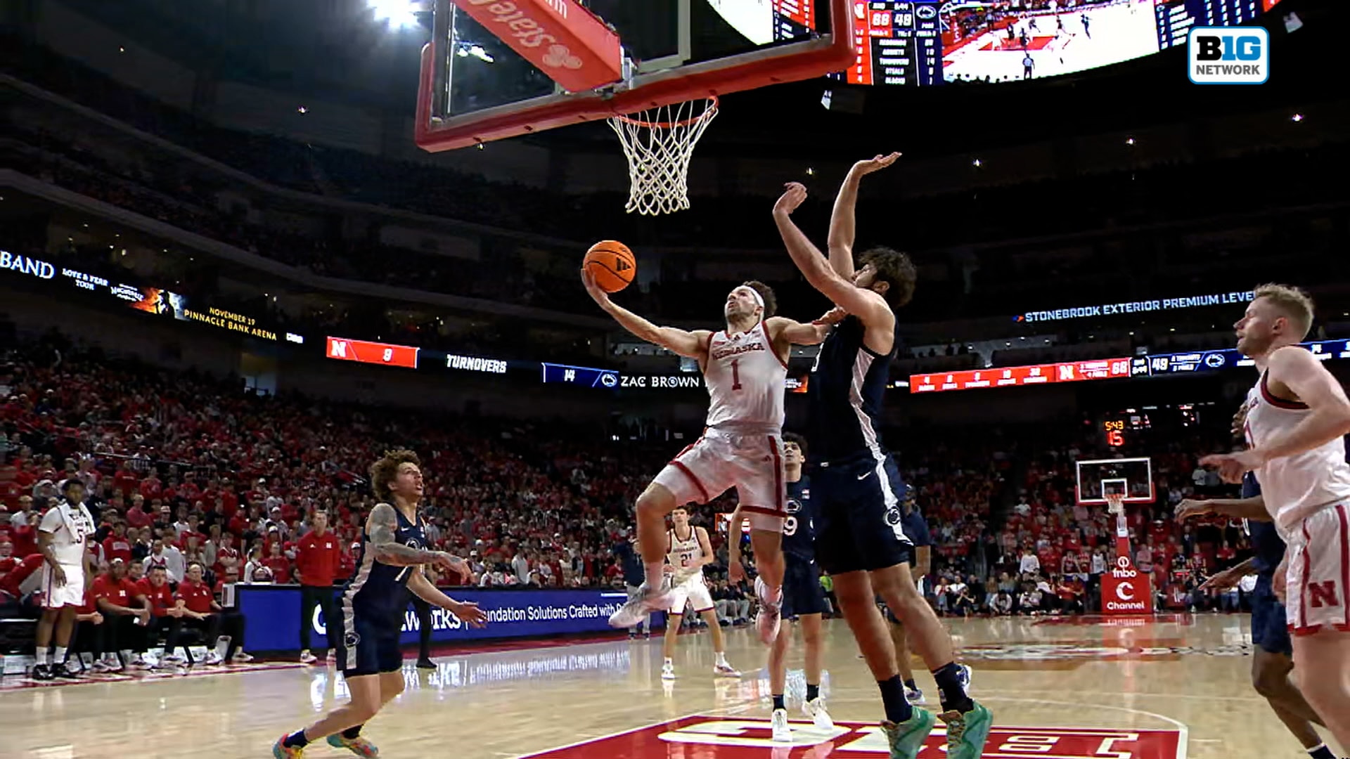 Nebraska's Sam Hoiberg attacks the rim and finishes for an and-one vs. Penn State