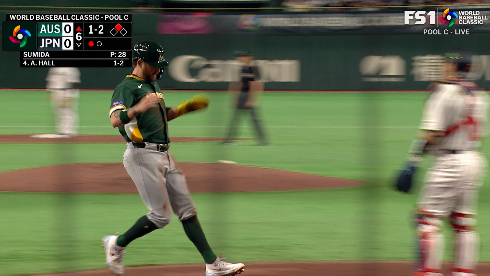 Australia's Aaron Whitefield steals third and scores after Japan