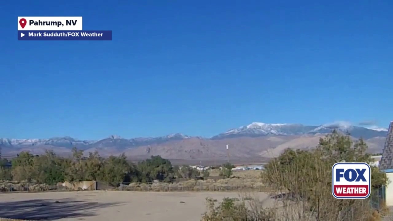 Clouds race across snow-capped mountains in Nevada