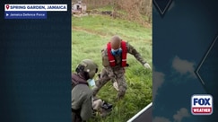 Elderly woman rescued by helicopter during Hurricane Melissa relief operations