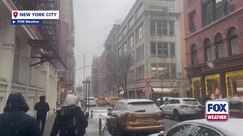New Yorkers trudge through snowy conditions in SoHo