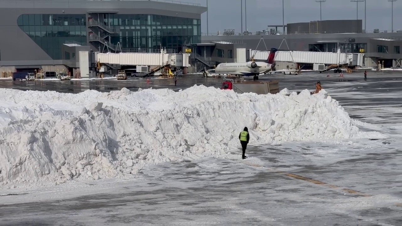 Crews clear off massive piles of snow at LaGuardia Airport