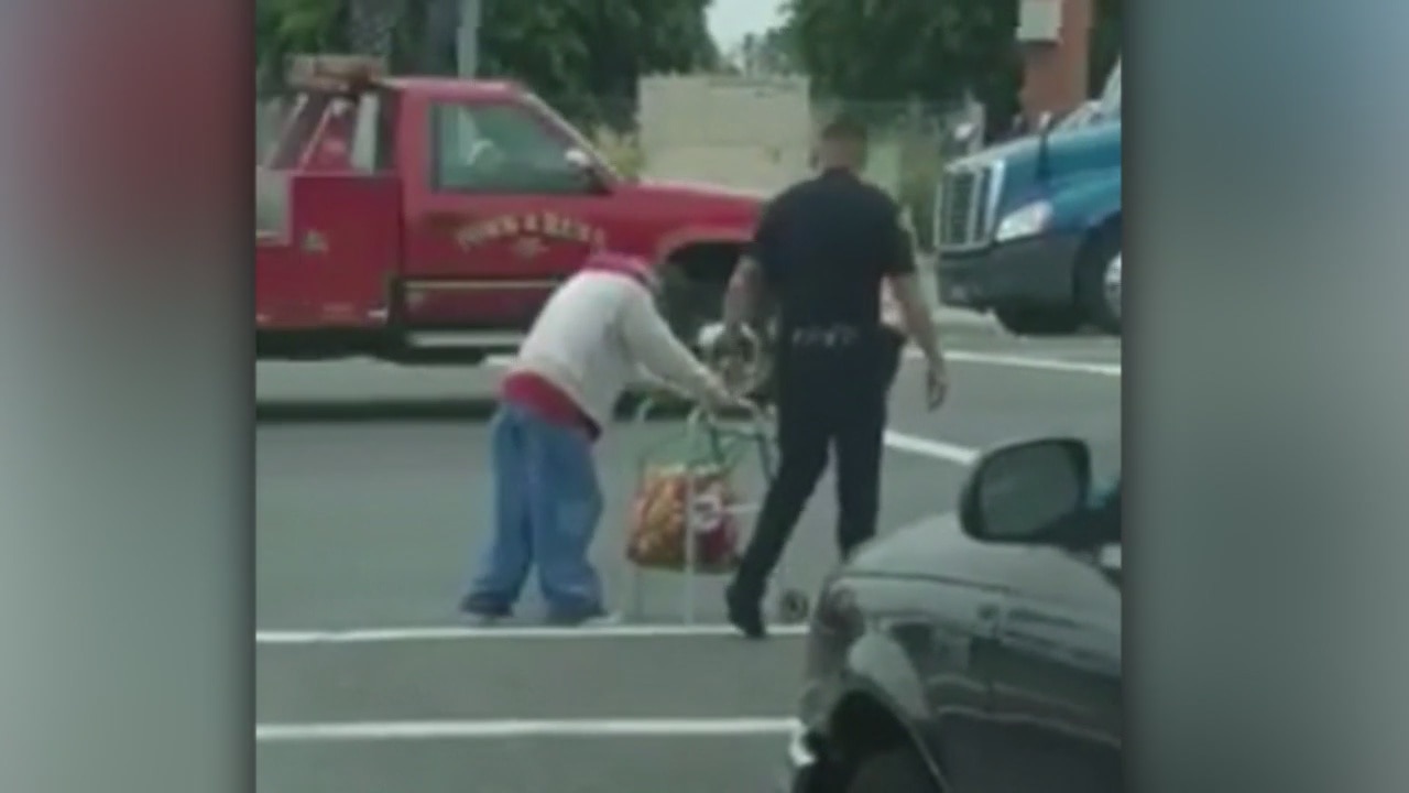 Anaheim cop helps elderly woman across the street