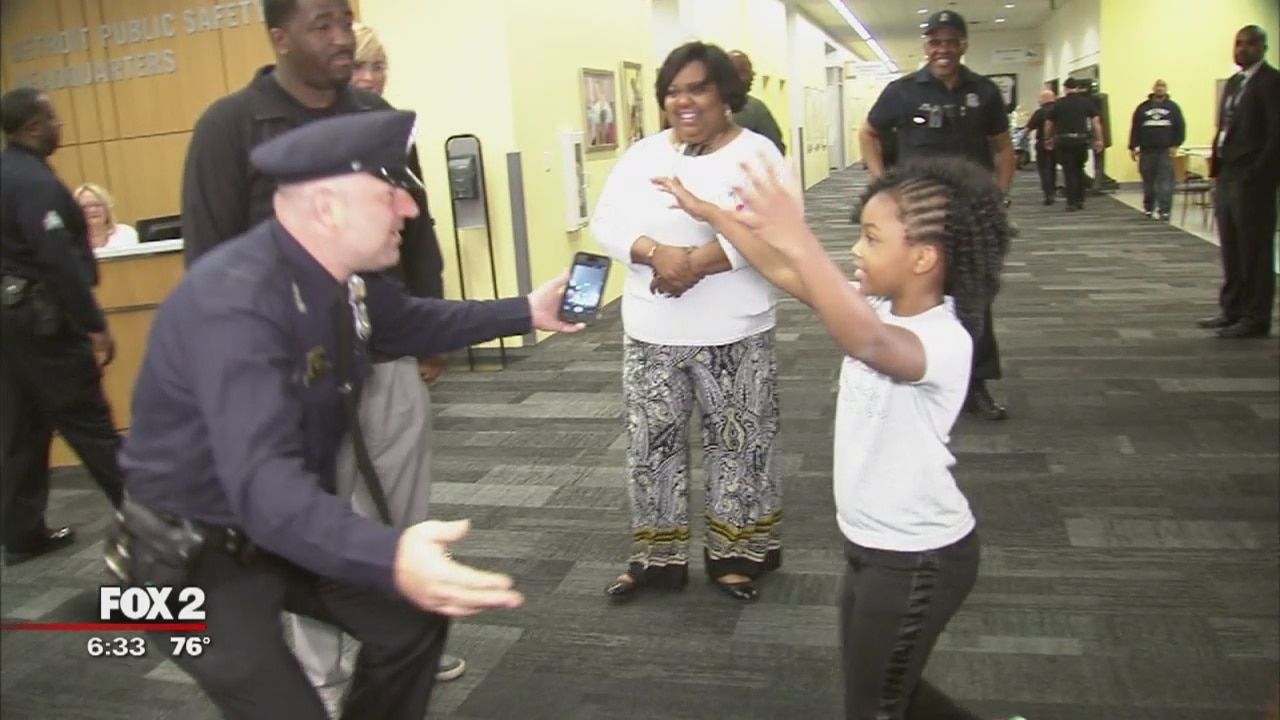 8-year-old traveling country hugging police officers stops in Detroit
