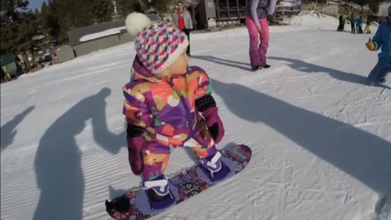One-year-old snowboarding