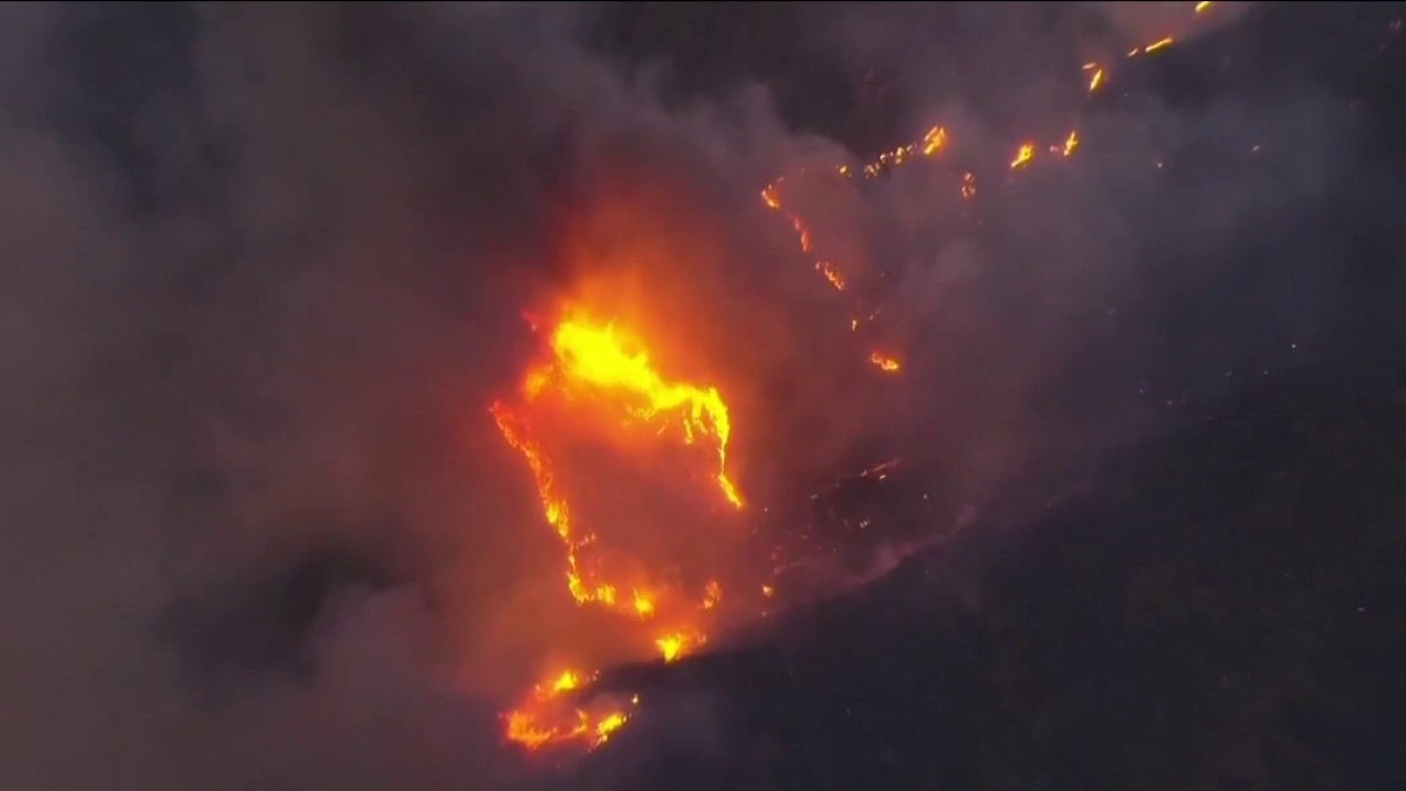 Wildfires, record rainfall and snow hit parts of US