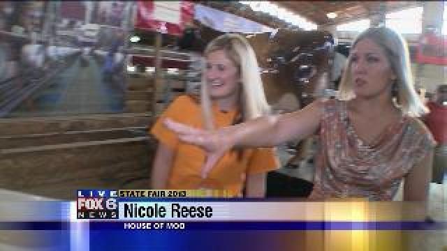 Laura learns about milking cows at State Fair