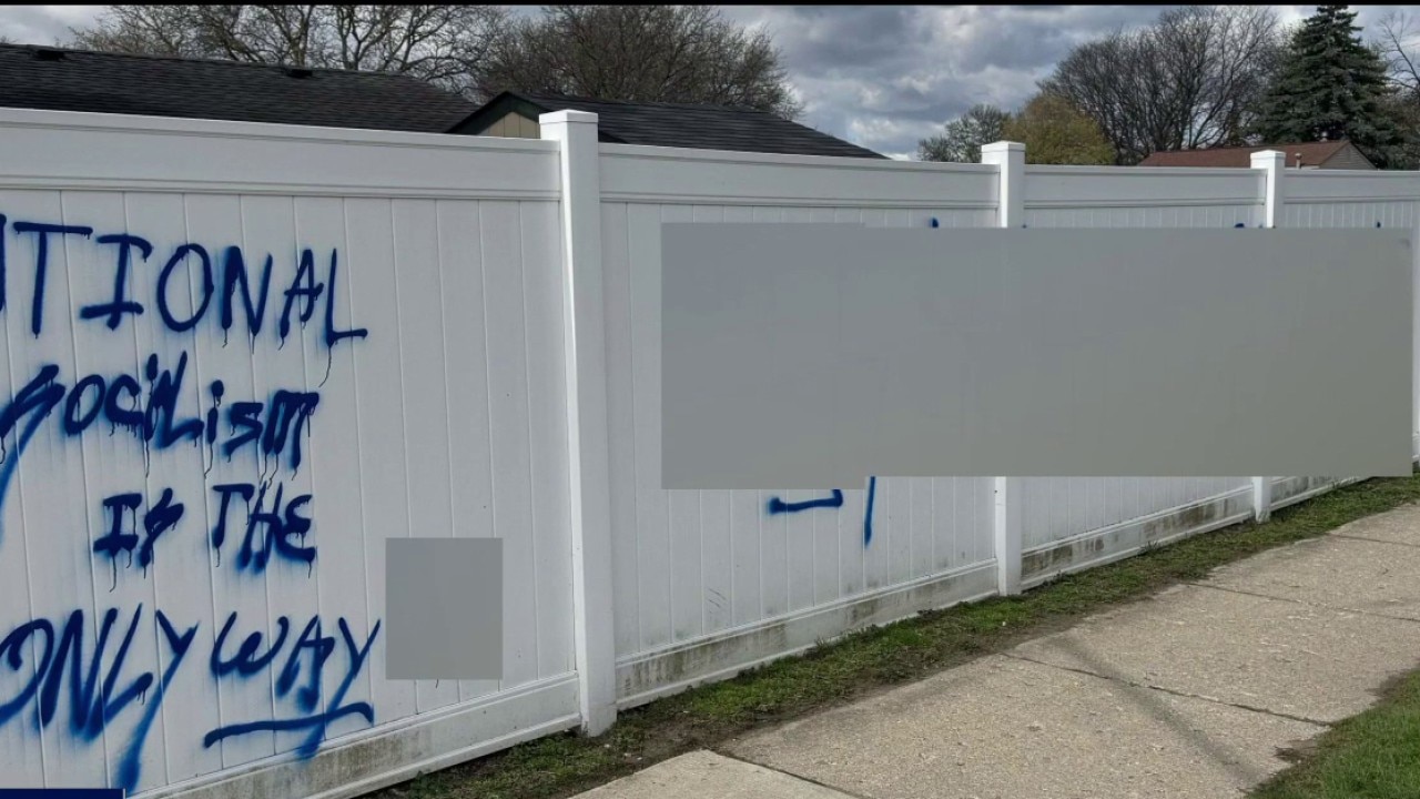 Two men arrested for allegedly vandalizing fence with hate speech