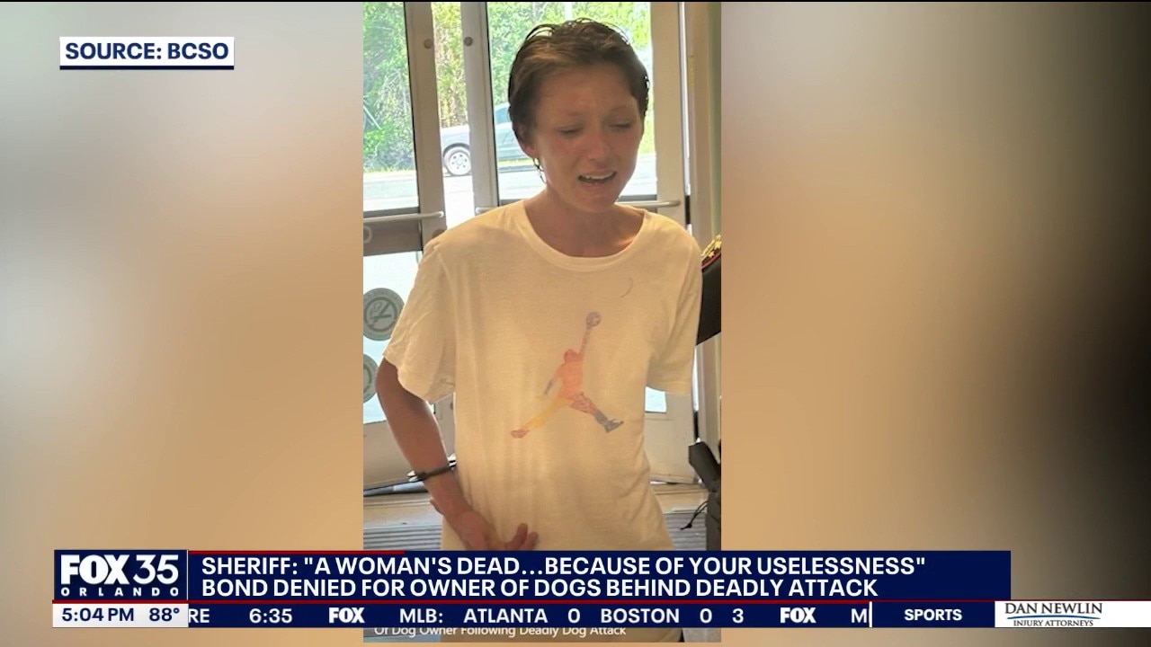 Woman charged after deadly dog mauling held without bond