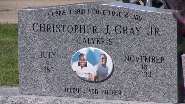 Closure: Family gathers around new headstone for "Caly Kris"