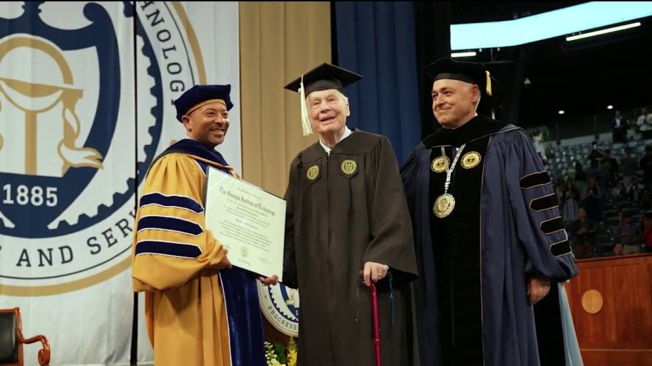 Ret. Col. Ken Grundborg walks graduation stage