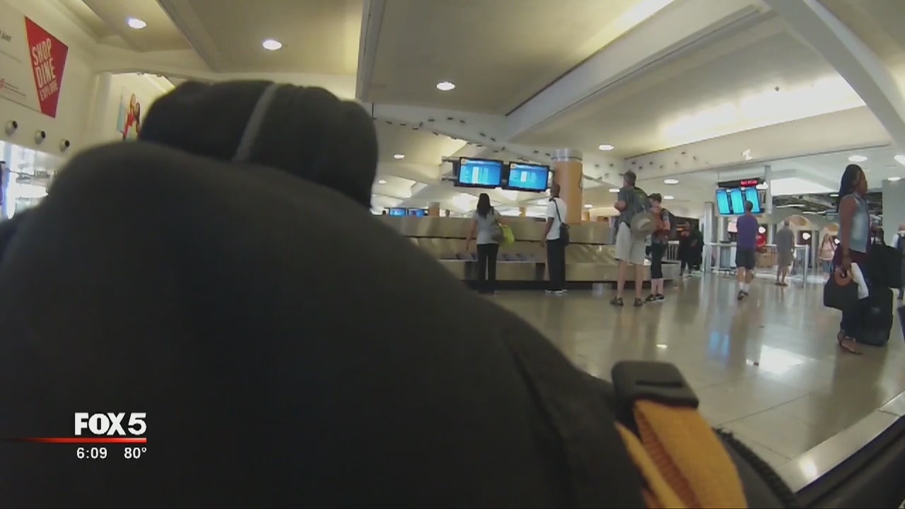 Child rides on baggage conveyor belt