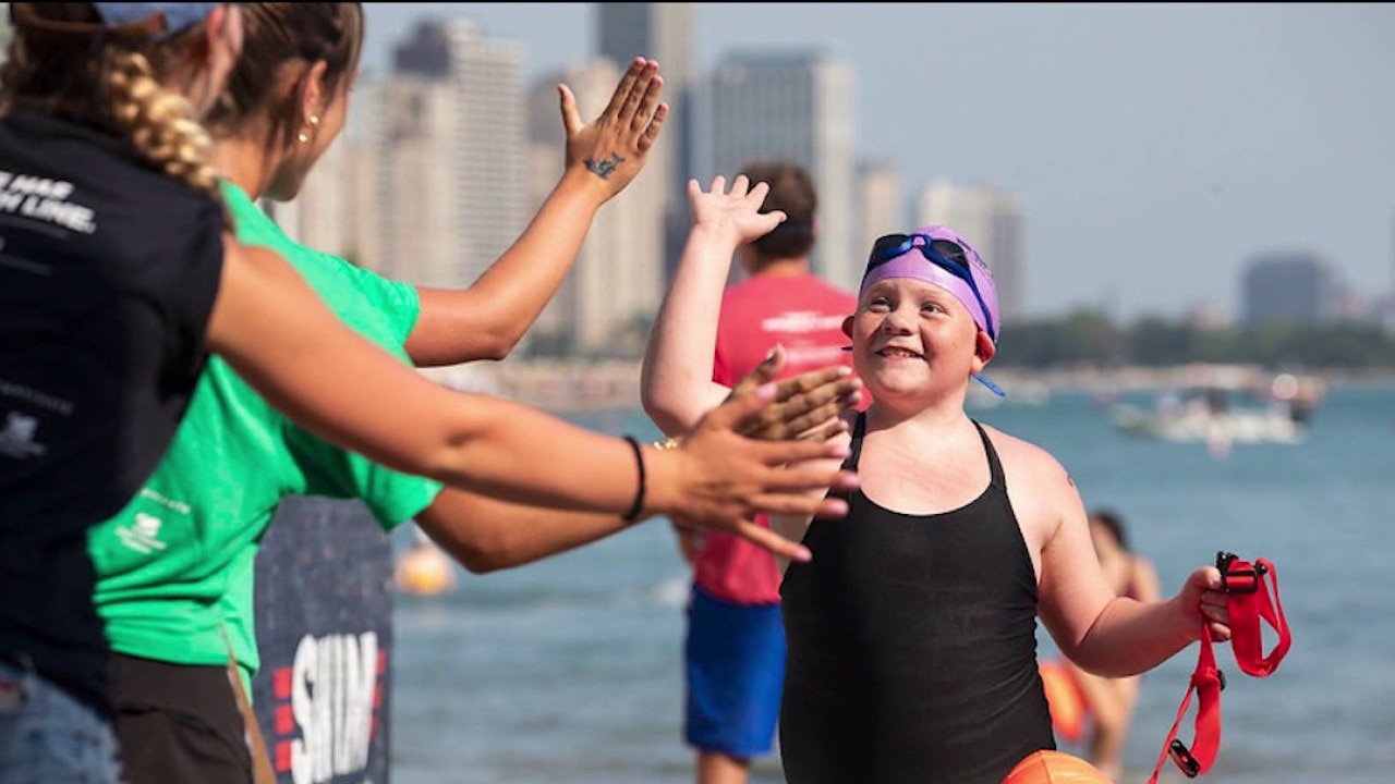Hundreds of swimmers dive into Lake Michigan for cancer research