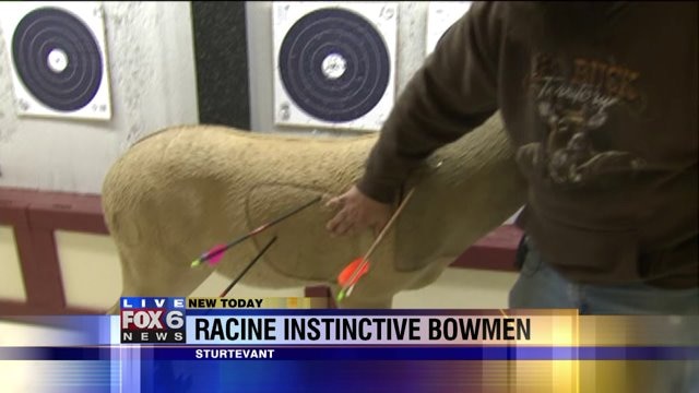 Laura learns how to shoot a bow and arrow