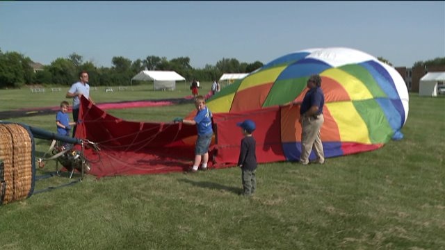 Chip helps set up hot air balloons ahead of Waterford Hot Air Balloon Festival