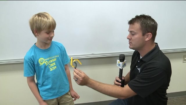 Chip talks with students at Brookfield Academy, checks out their designs
