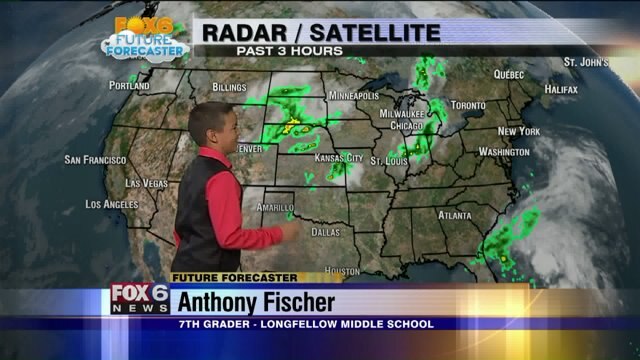 Anthony Fischer helps Meteorologist Rob Haswell with the weather