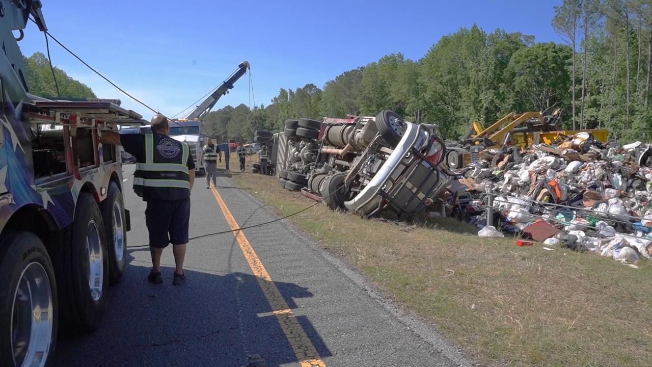 Driver hospitalized after trash truck rolls over on I-40 in Johnston County