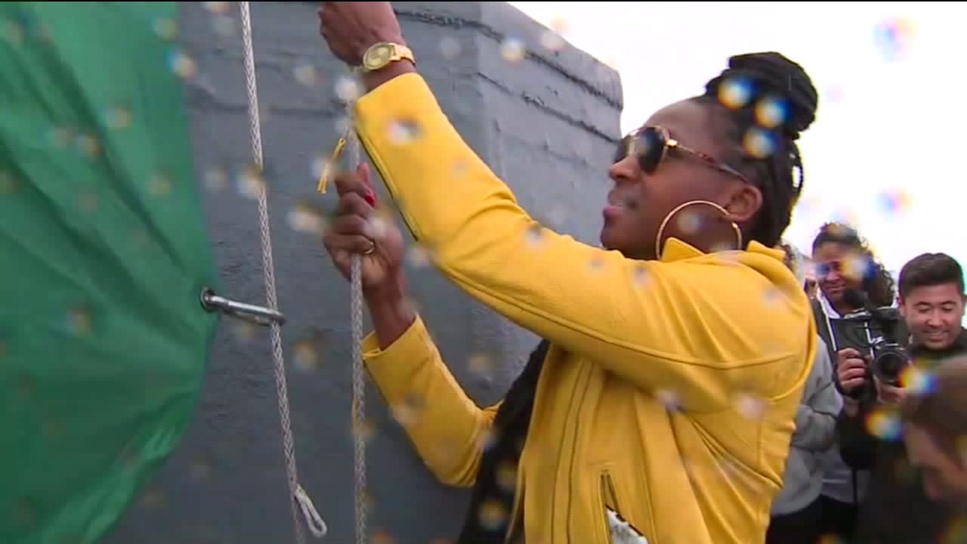Storm members raise flag at Space Needle