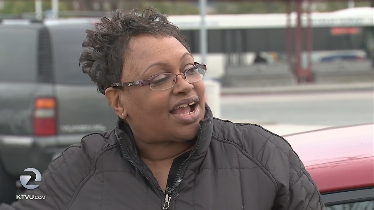 Woman finds man in back seat of car