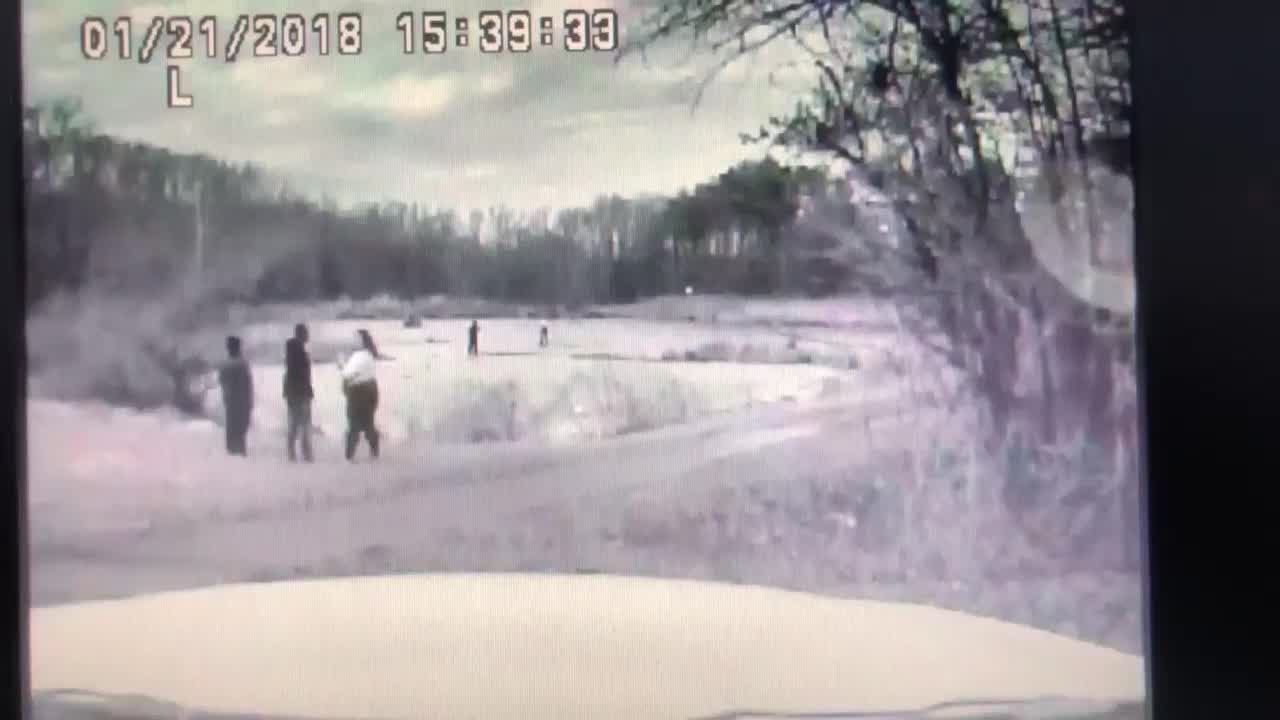 Dash cam video captures an officer falling into an icy pond during a rescue