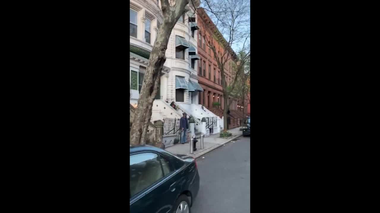 Harlem neighbors sing from doorsteps in support of health care workers