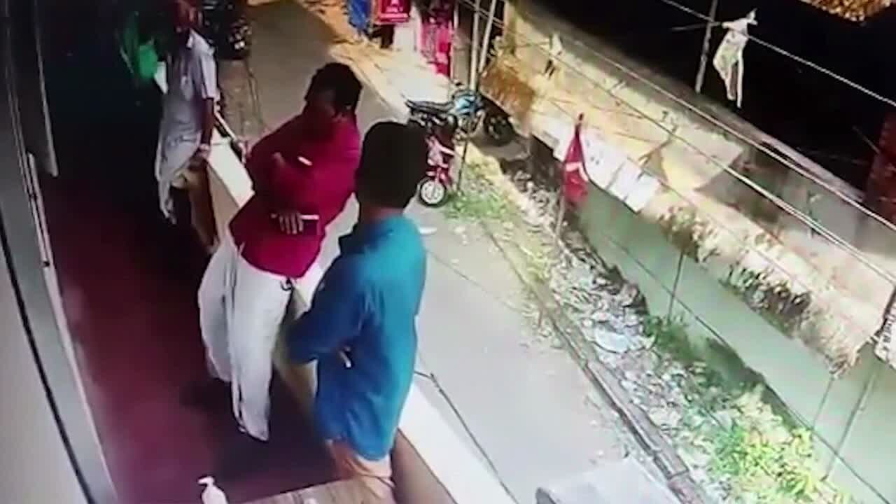 Man saved after nearly falling off balcony.