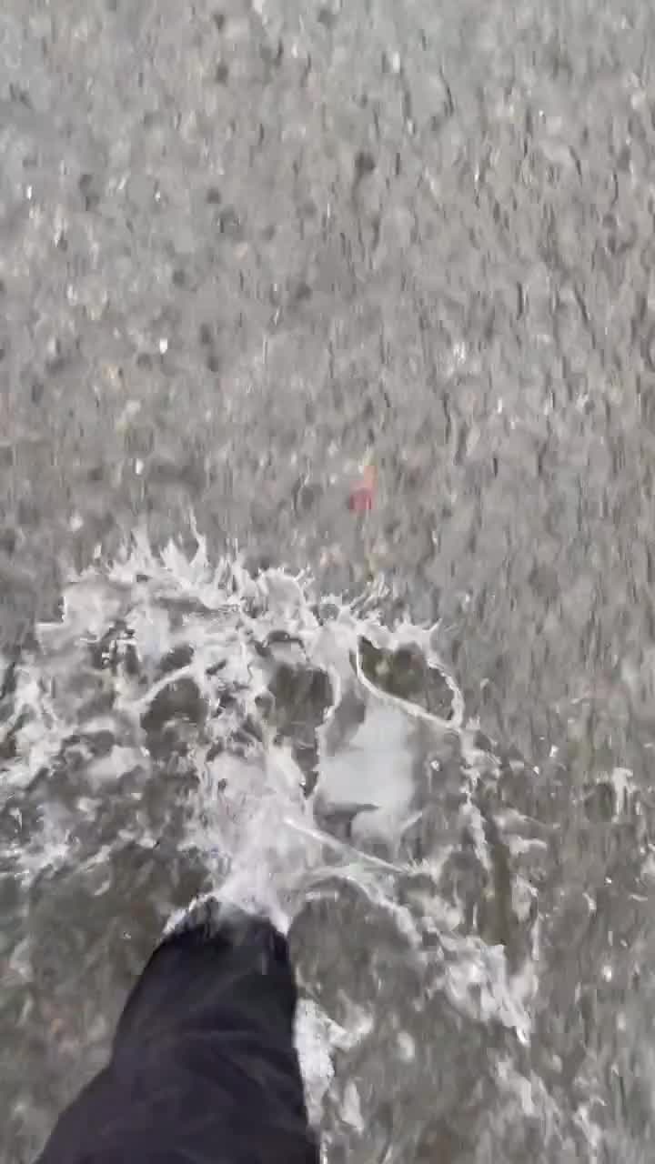 Students wade through flooded parking lot as Tropical Storm Nicholas hits Louisiana