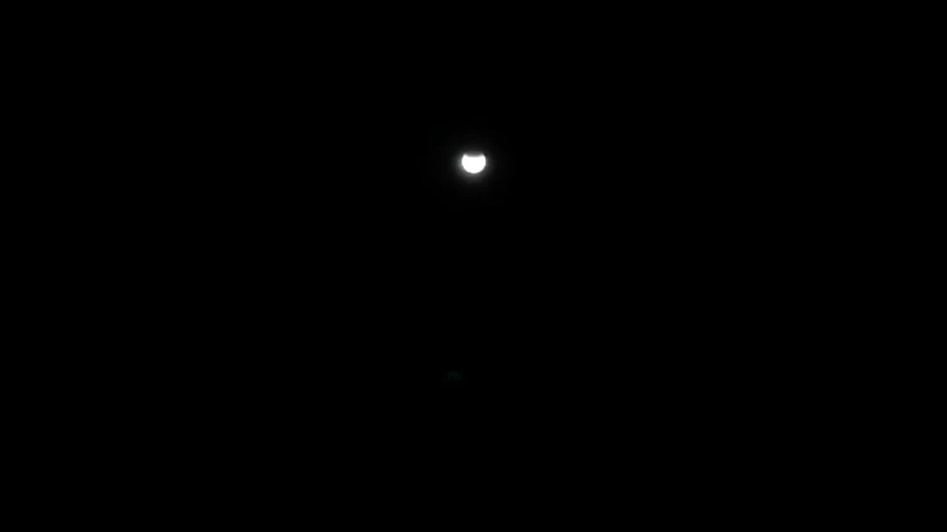 Stargazers marvel as partial lunar eclipse begins