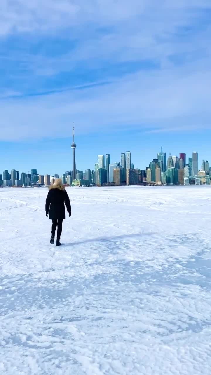 Woman Treads Across Frozen Harbor in Toronto