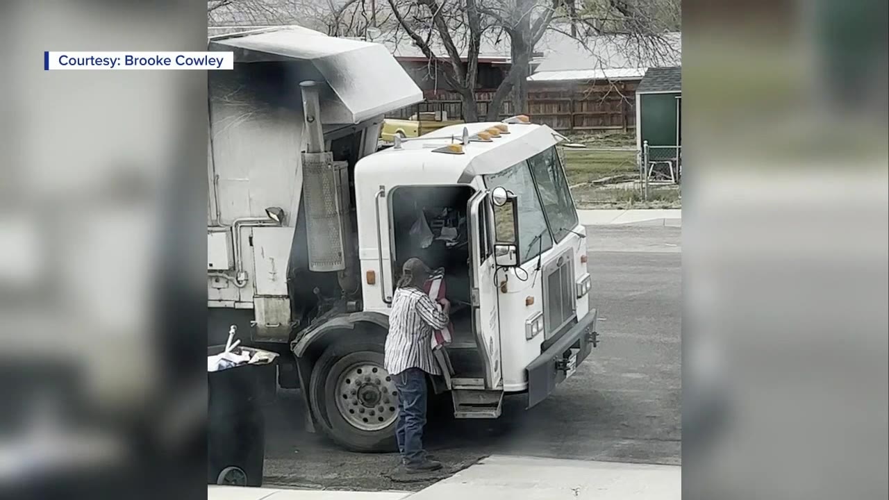 Garbage man pulls flag out of trash can, folds it properly