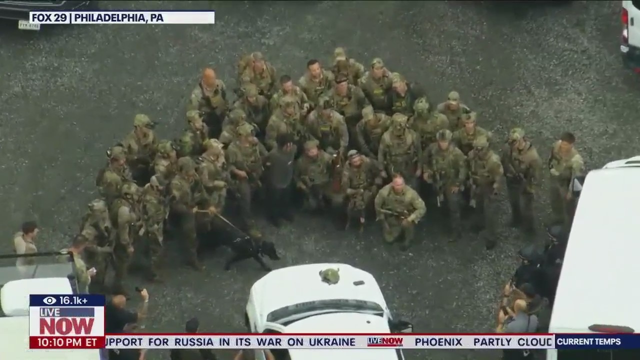 Police pose for photo after capturing killer