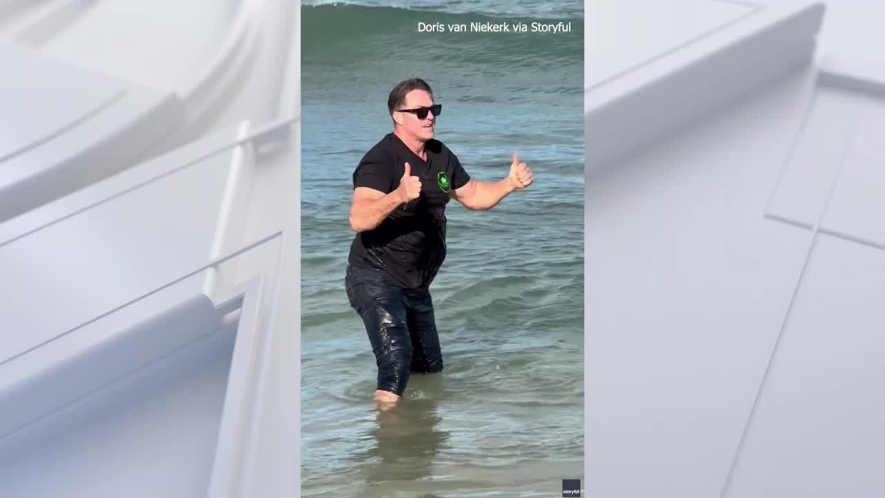 Rugby legend Percy Montgomery rescues stranded dolphin calf near Cape Town