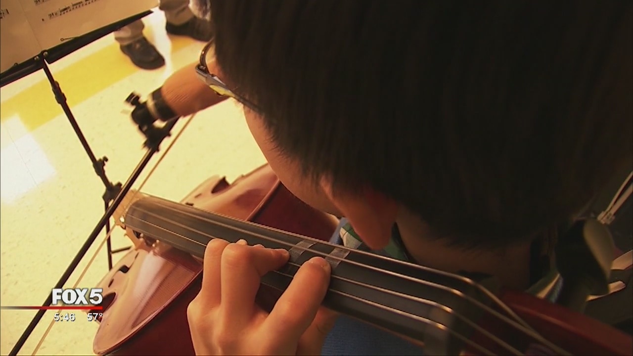 Young Georgia siblings play musical instruments with artificial hands