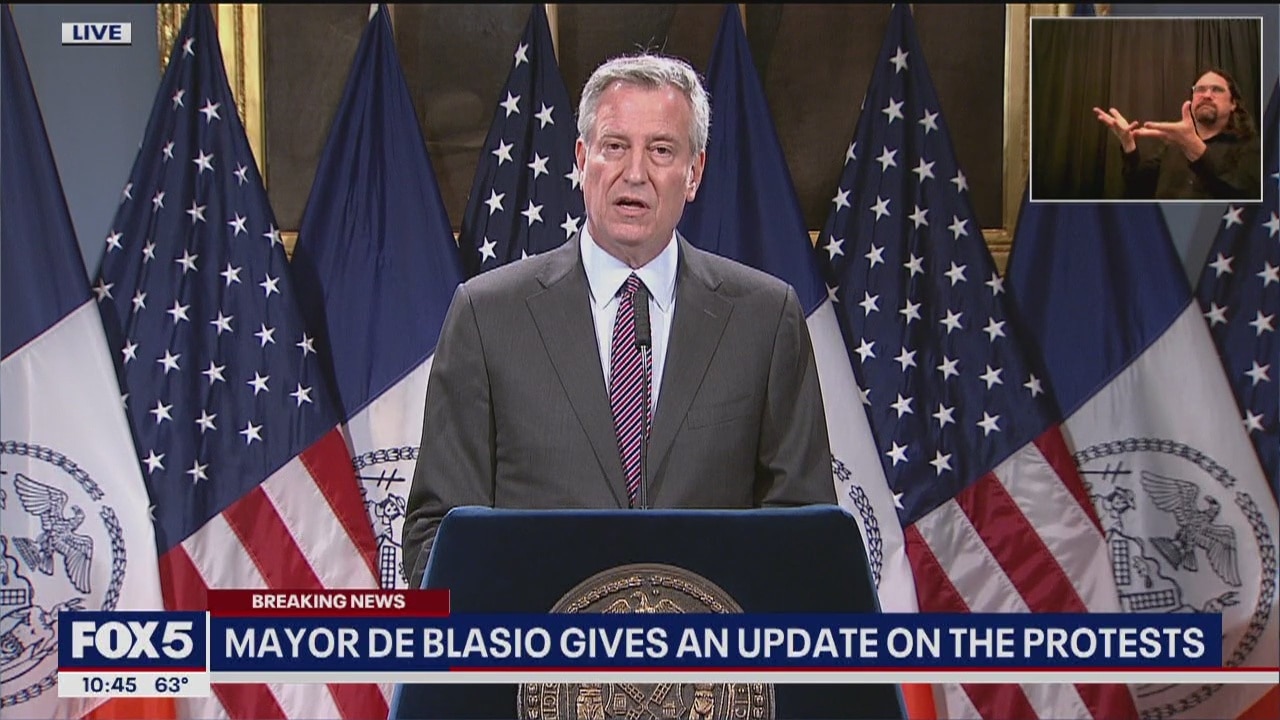 Mayor Bill de Blasio reacts to protests
