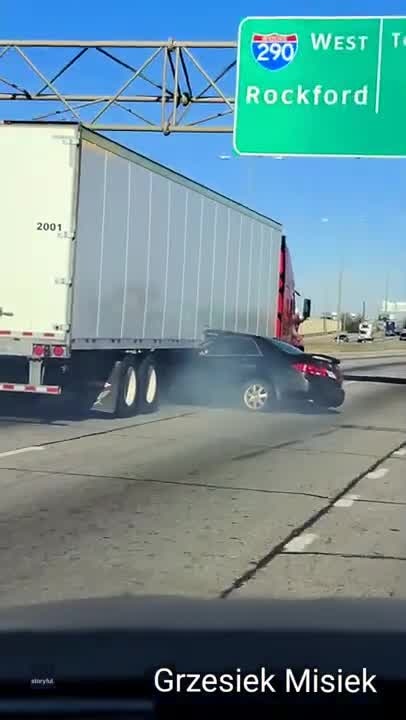 Truck drags car down highway