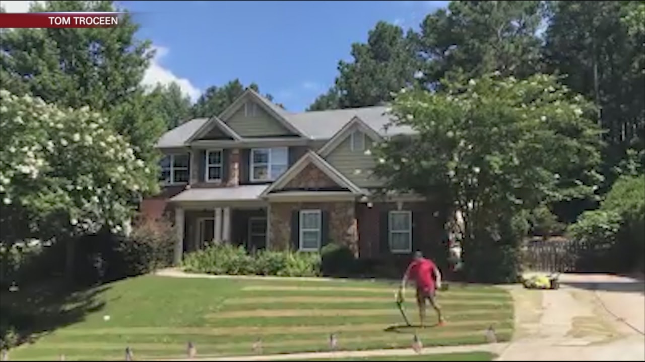 Man mows flag into lawn