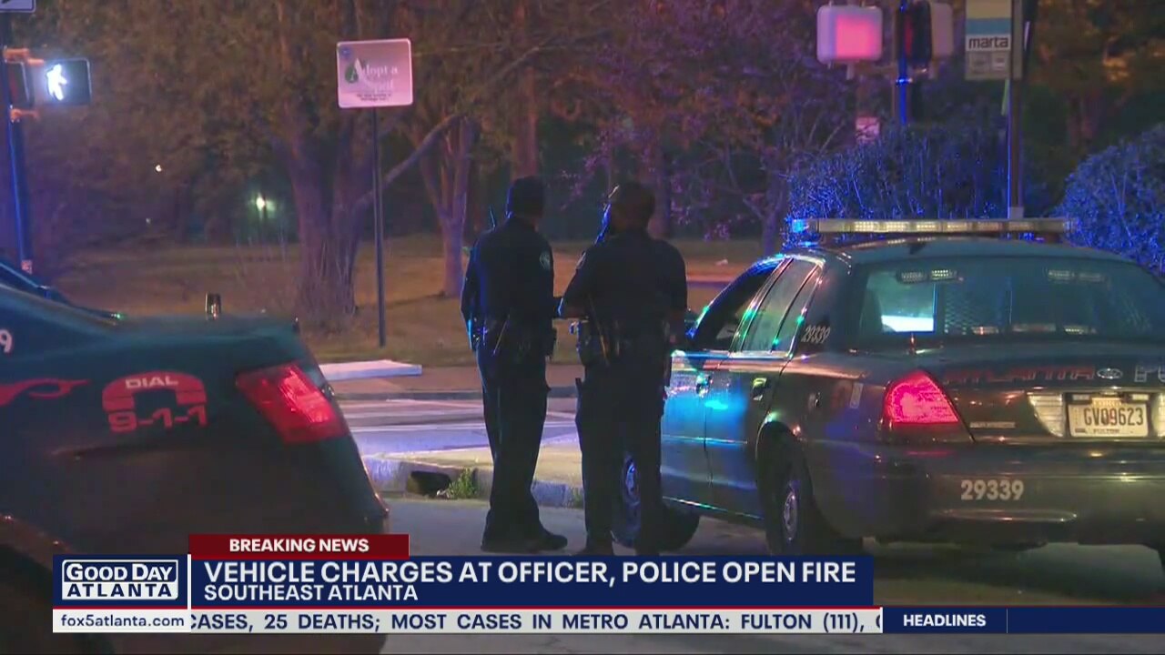 Vehicle charges at police, officers open fire