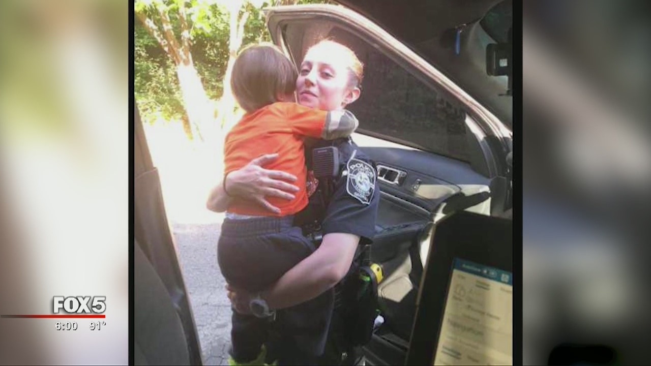 Young child clings to officer