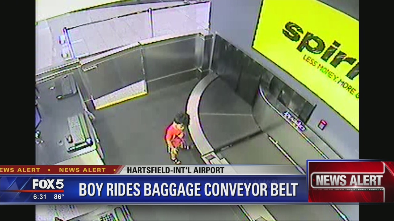Child rides baggage conveyor belt